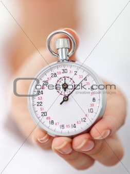 Stopwatch in womans hand - closeup