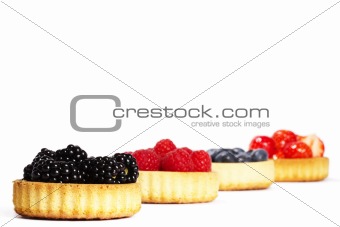 blackberries and other berries in tartlet cakes