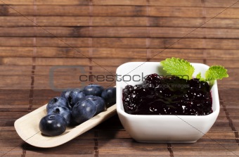 blueberry jam and blueberries on a shovel