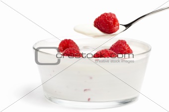 raspberry on a spoon over a dessert with raspberries