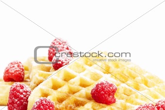sugar covered raspberries on waffles with syrup