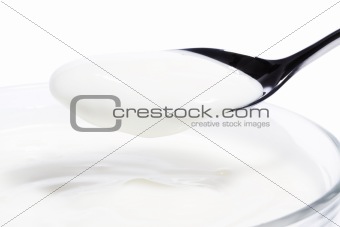 yogurt on a spoon over a dessert
