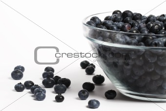 bowl full with a lot of blueberries with some aside