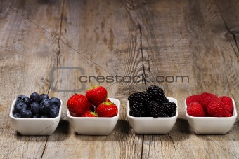 row of wild berries in bowls