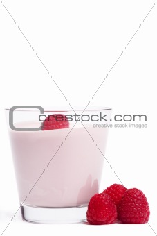 raspberry on a milkshake with raspberries aside