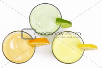 three cold citrus fruit milkshakes from top
