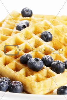 waffles with sugar covered blueberries and syrup