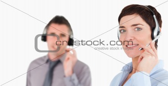Close up of office workers using headsets