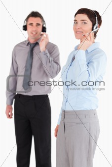 Portrait of managers speaking through headsets