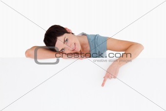 Serene woman pointing at blank space