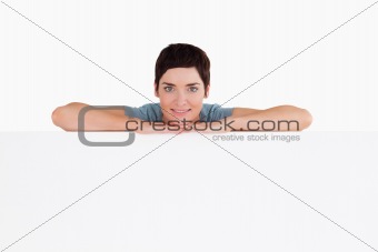 Serene woman relying on a blank panel
