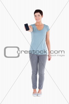 Smiling woman showing a smartphone