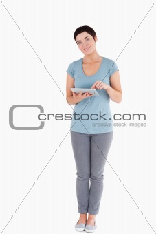 Dark-haired woman using a tablet computer