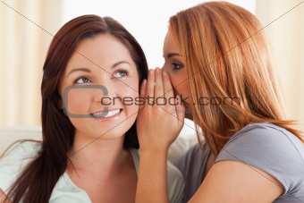 Gorgeous woman being told a secret