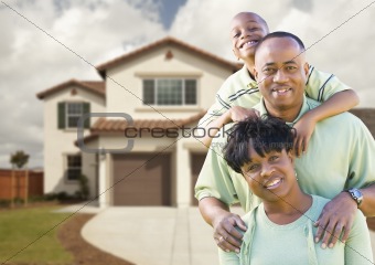 Attractive African American Family in Front of Beautiful House.