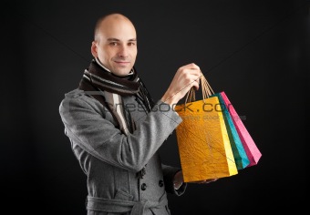 Young men with paper presents bags