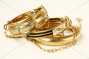 gold female jewelry, bracelets and chains