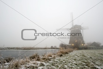 Windmill on a foggy winter morning