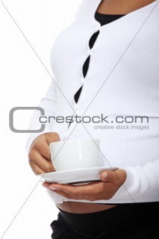 Pregnant woman holding cup of coffee