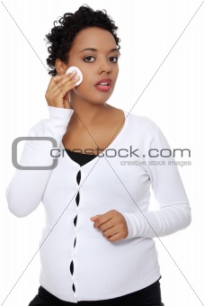 Young  pregnant woman removing make-up
