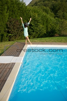 woman jumping on pool corner