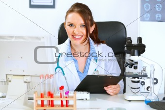 Smiling doctor woman working in office
