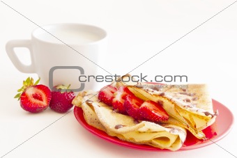 sweet pancakes with strawberry and cup of milk