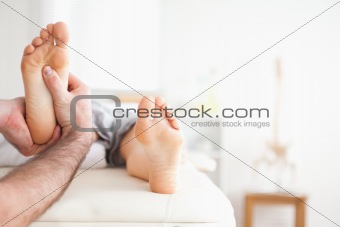 Male masseur doing a reflexology massage
