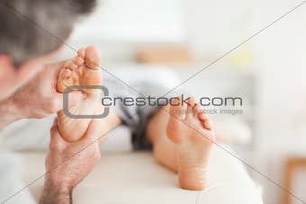 Lying Woman getting a reflexology massage