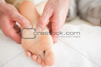 Man massaging a woman's foot