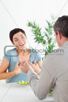 Man proposing to his excited girlfriend during dinner
