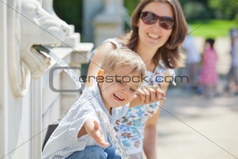 Mother with her son playing with water