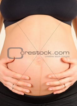 pregnant woman embracing the belly
