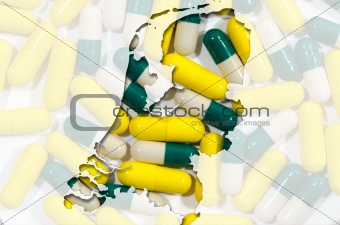 Outline map of Netherlands with pills in background