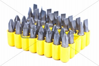A set of screw tips in a yellow container