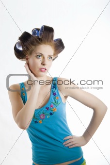 Young beautiful woman in blue shirt is getting her hairstyle