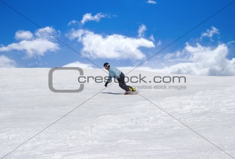 Snowboarder against blue sky