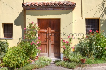 Small courtyard and wooden door in Roddi, Italy.