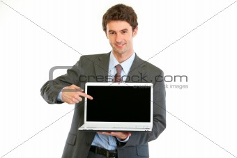Modern businessman pointing on laptops blank screen
