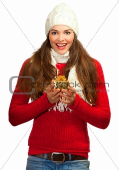 Beautiful young surprised woman holding a gift