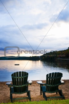 Wooden chairs at sunset on beach