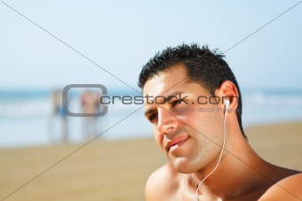 guy on the beach  listening to music