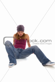 pretty girl- teenager in jeans sitting on a white background