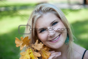 pretty autumn woman in yellow park