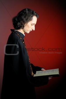 conceptual portrait of Praying priest with wooden cross reading 