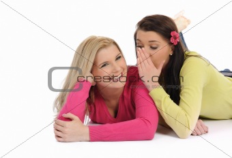 Two young pretty girls gossiping and enjoying conversation
