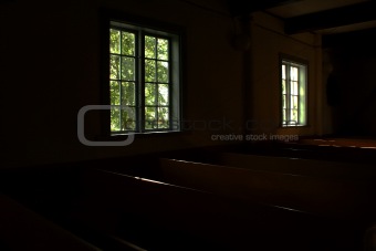 Dark rooms of church lighted by windows