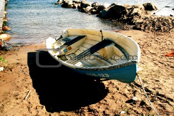 Boat on sandy beach at sunny day