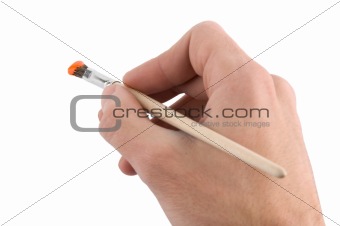 hand holding paint brush isolated over white background