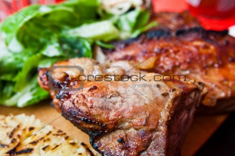 Grilled steak - Grilled meat ribs on the plate with hot sauce 